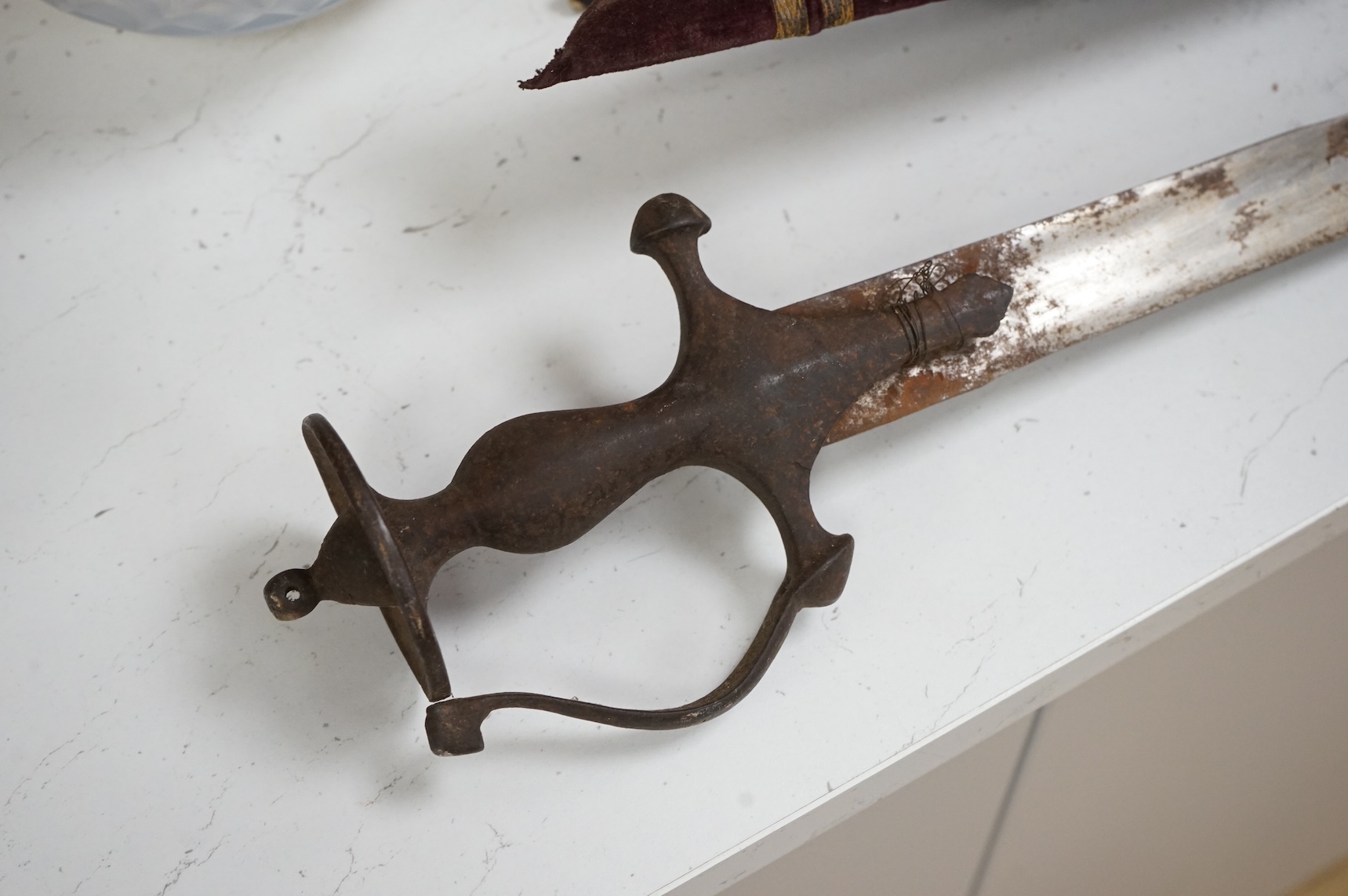 An Indian Tulwar sword, in scabbard and two small kukri, largest 93cm long.